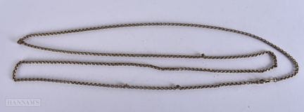 A LONG ANTIQUE YELLOW METAL CHAIN. 150 cm long.