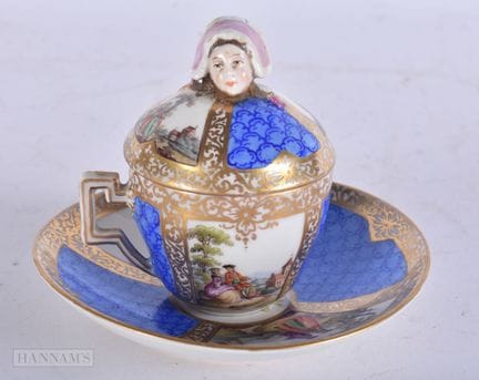 AN UNUSUAL ANTIQUE GERMAN PORCELAIN CUP AND SAUCER