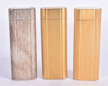 TRES ENCENDEDORES DE CARTIER. 7,25 cm de altura. (