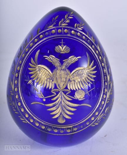 A RUSSIAN IMPERIAL BLUE GLASS GILDED EGG. 9.5 cm x