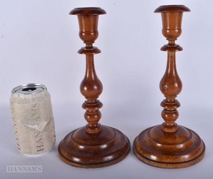 A PAIR OF ANTIQUE FRENCH TREEN CARVED WOOD CANDLES