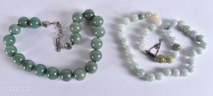 TWO CHINESE JADEITE NECKLACES. Largest 58 cm long,