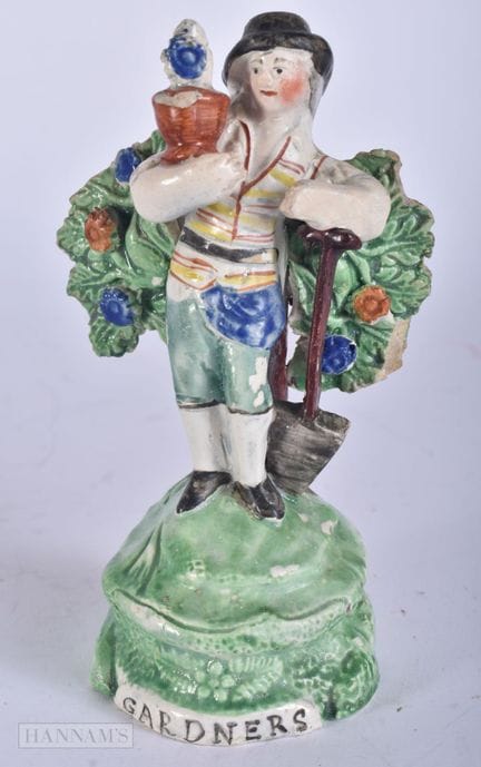 AN EARLY 19TH CENTURY STAFFORDSHIRE FIGURE OF A GA