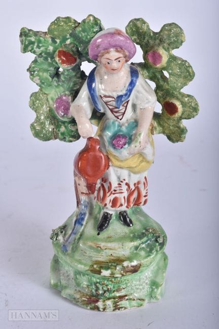 AN EARLY 19TH CENTURY STAFFORDSHIRE RALPH SALT FIG
