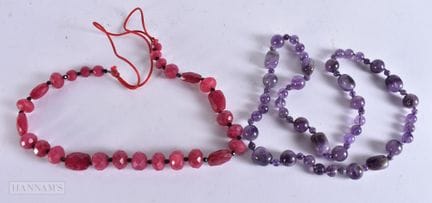A CARVED AMETHYST NECKLACE together with a pink st