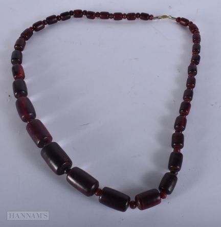 A STAINED MIDDLE EASTERN RED HORN NECKLACE. 161 gr