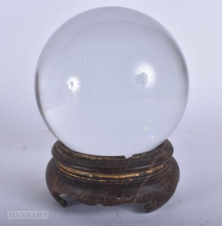 A MYSTICAL CRYSTAL BALL ON STAND. 17 cm x 10 cm.