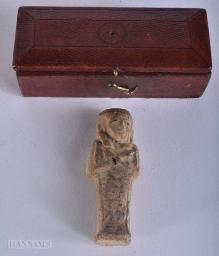 AN ANTIQUE LEATHER BOX containing an ushabti. 8 cm