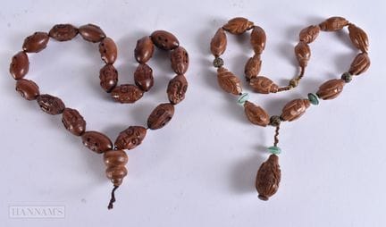 TWO CHINESE CARVED HEDIAO NUT NECKLACES. Largest 5