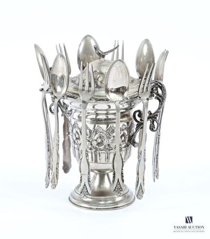 A metal-lidded jam jar on a pedestal; it features 