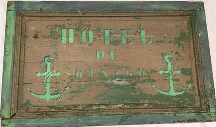 A vintage wooden sign reading “Hôtel de Dinard” wi