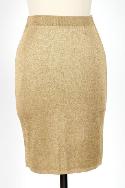 COURREGES. 
Falda elástica de punto dorado. 
Hacia