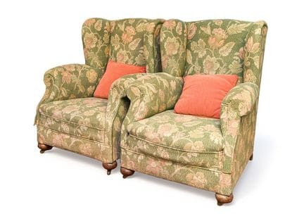 A pair of wingback chairs with floral and botanica