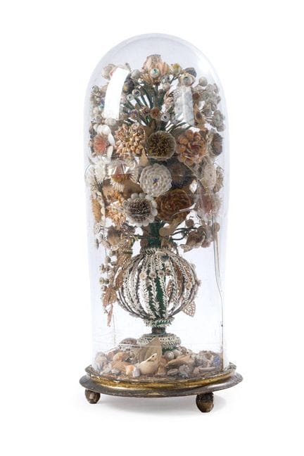 Lantern with a composition of seashells inside for