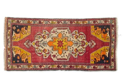 Caucasian wool rug with a maroon field, decorated 