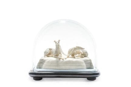 A biscuit porcelain figurine depicting two reclini