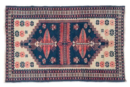 Caucasian wool rug with geometric patterns on a be