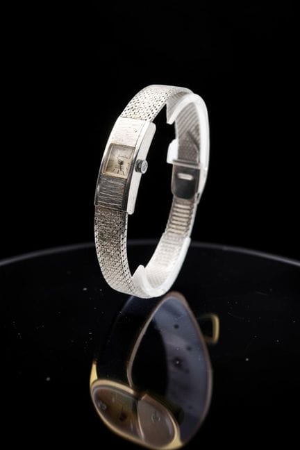 SANDOZ
Steel watch with a rectangular case, featur