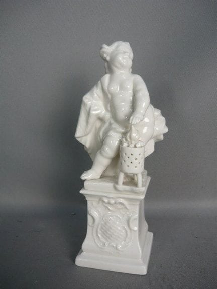 A putto warms his hands by the fire. Nymphenburg. 