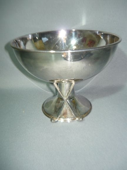 Golf trophy with crossed golf clubs. Silver-plated