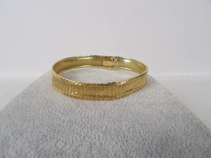 Bracelet souple en or jaune 18K à décor stylisé fl