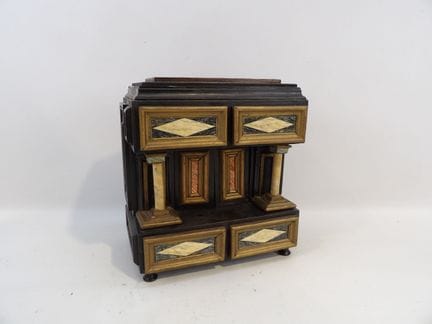Small, portable cabinet made of blackened wood wit