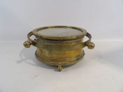 Brass marine compass resting on four legs. Dimensi