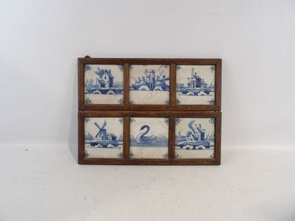 A set of 6 blue polychrome earthenware tiles on a 