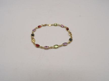 Bracelet en or jaune 18K et pierres colorées. Poid