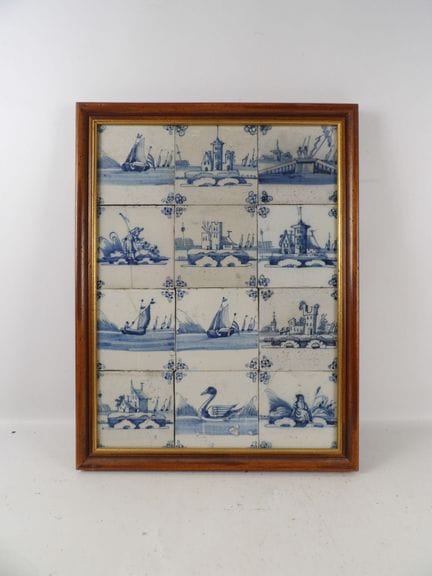 Set of 12 blue polychrome earthenware tiles on a w