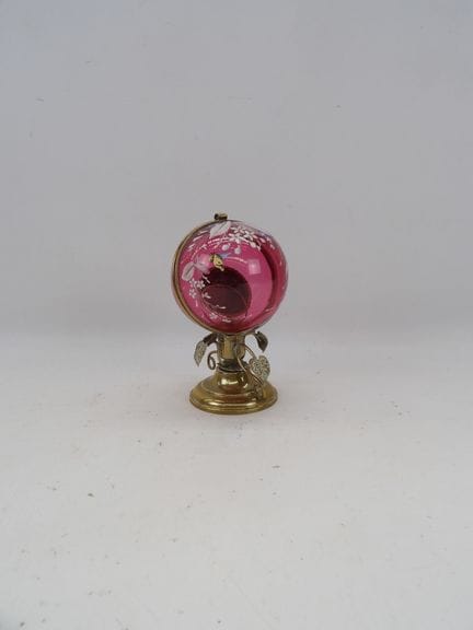 Pink glass and enameled ball-shaped watch stand de