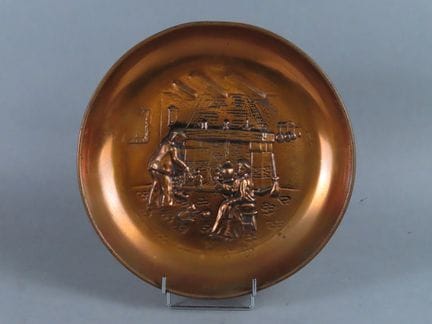 Copper soup plate decorated with a repoussé design