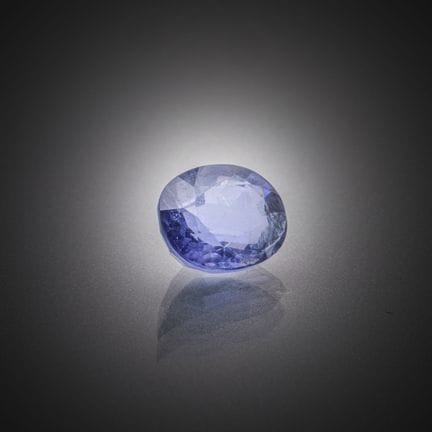 Iolite violette bleutée ovale sur papier.
Poids : 