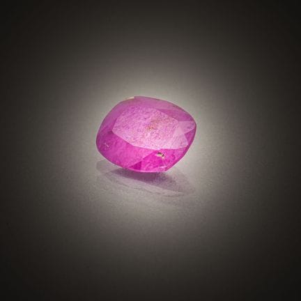 Cushion-cut ruby on paper.
Weight: 1.58 ct.
Dimens