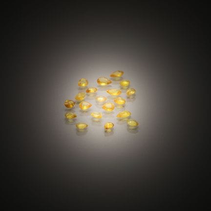 Set of nineteen pear-shaped yellow sapphires on pa