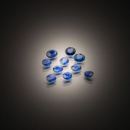 Set of ten oval and pear-shaped sapphires on paper