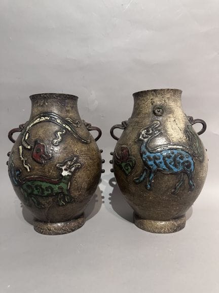 CHINA
Pair of metal baluster vases with a brown pa
