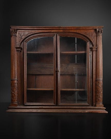 A wall-mounted display case made of carved natural