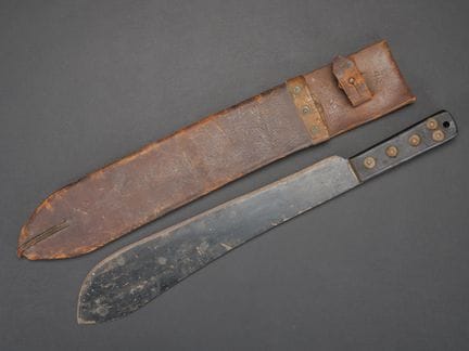 British machete. Black grip scales, secured by fiv
