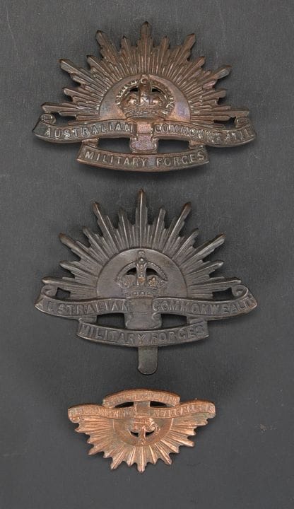 Australian cap badges. Includes a bronze-colored m