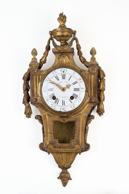 Chased ormolu wall clock decorated with a fire pot