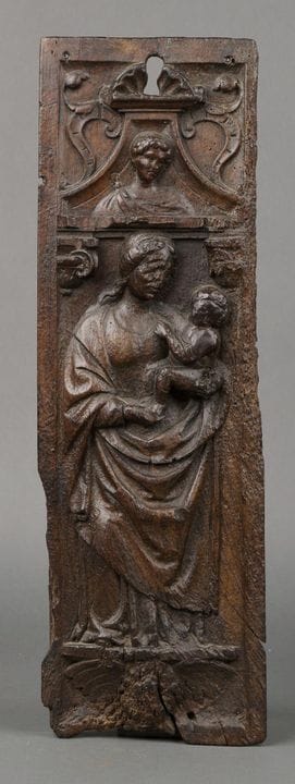 A low-relief panel in walnut depicting the Virgin 