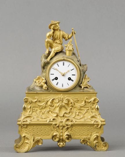 CLOCK depicting a young gardener, made of gilded b