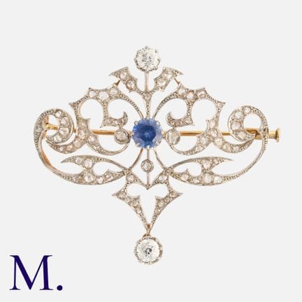 HENRI VEVER, une broche en or 18 carats sertie de 