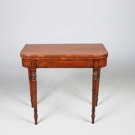 REGENCY MAHOGANY AND EBONISED STRUNG CARD TABLE 
'