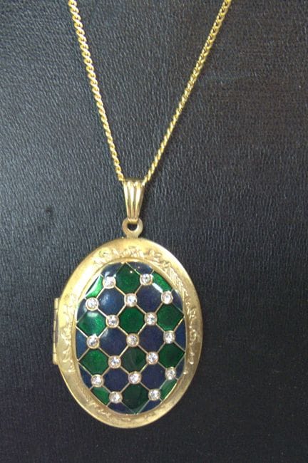 Unique costume jewelry locket with a chain.