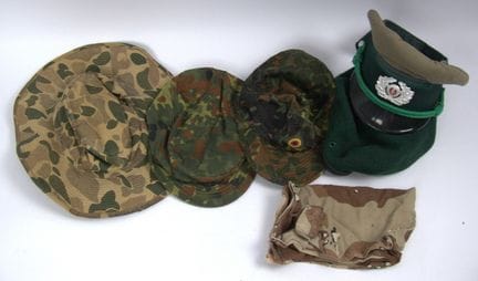 A variety of military headgear, including a peaked