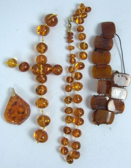 A batch of amber jewelry, some of which is damaged