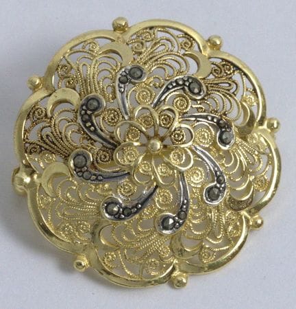 Delicate brooch with an intricate floral pattern, 