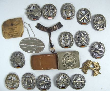 Lot of "Bundeswehr" badges, dog tags, and belt buc